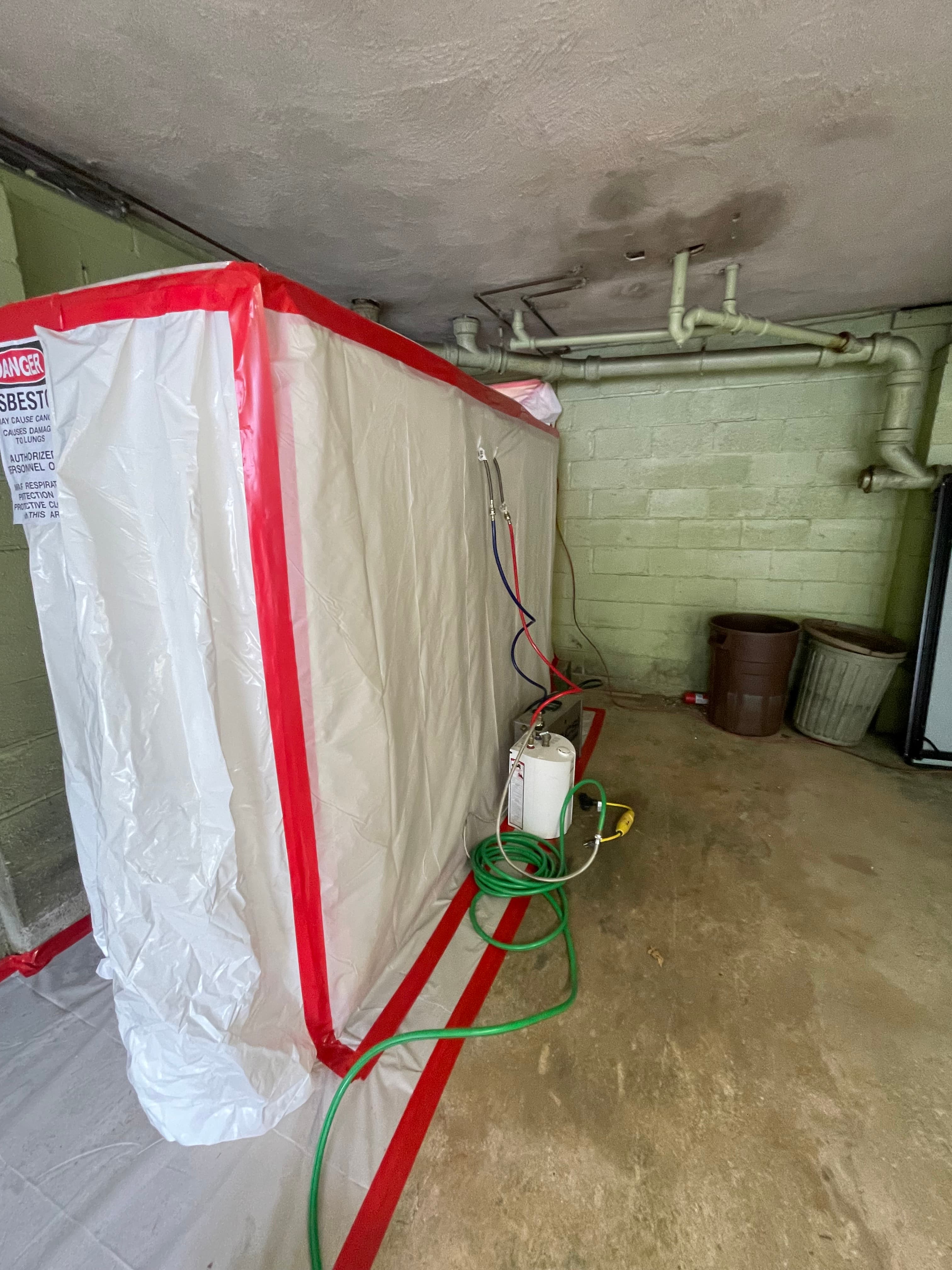 Asbestos tile removal with decontamination unit